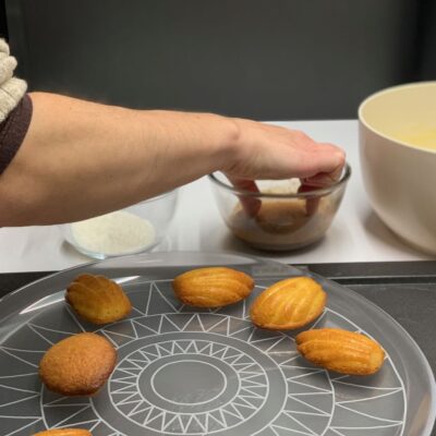 Recette madeleines au chocolat et noix de coco - Démouler et tremper les madeleines sur une seule face dans le chocolat fondu d'abord, puis dans la noix de coco.