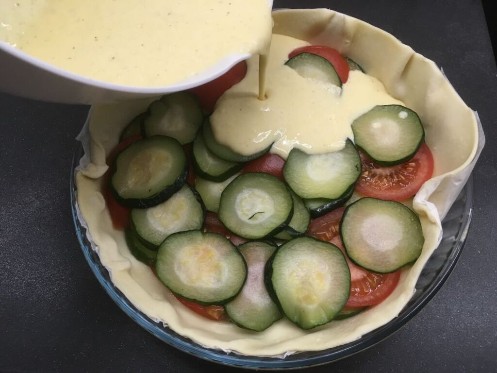 Recette quiche aux tomates et aux courgettes - Verser la préparation dessus et parsemer de thym.
